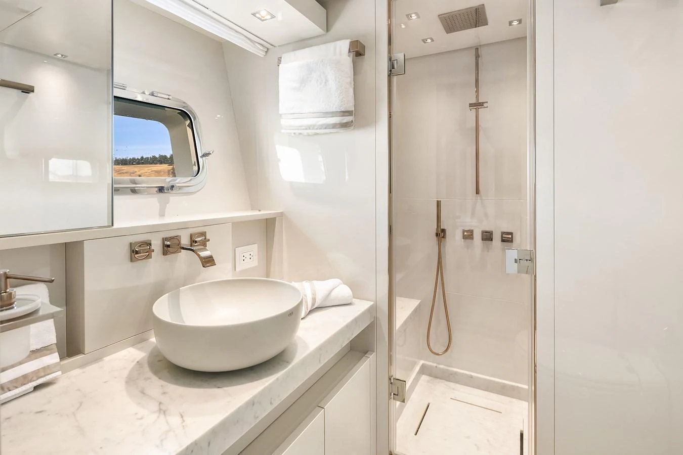 The yacht's bathroom features a sleek design with a modern sink and a spacious shower area. aboard ESSENZA Yacht for Sale
