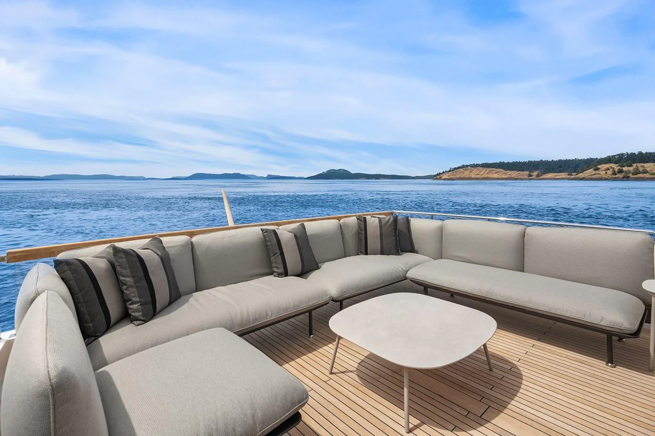 The aft deck features a spacious and comfortable seating area with panoramic ocean views. aboard ESSENZA Yacht for Sale