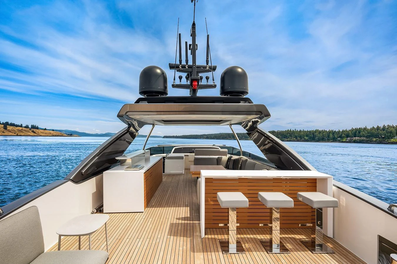 The yacht's flybridge offers a spacious and luxurious outdoor area with ample seating and a bar, perfect for entertaining while enjoying scenic views. aboard ESSENZA Yacht for Sale