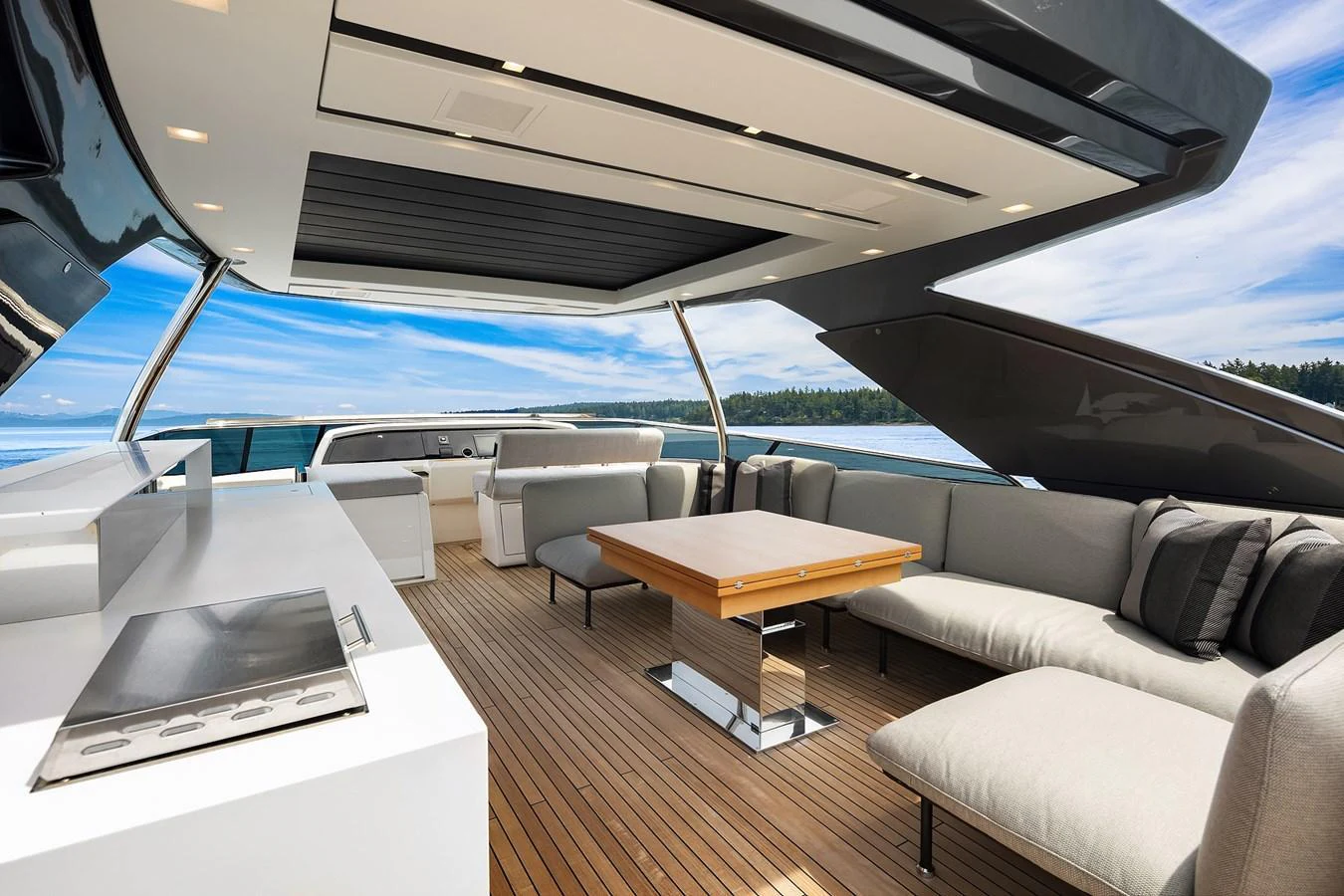 The flybridge offers a spacious and luxurious outdoor seating area with modern amenities. aboard ESSENZA Yacht for Sale