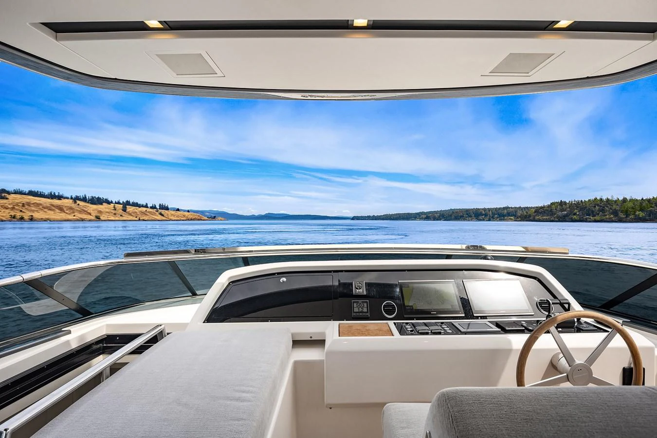 The helm station offers a panoramic view of the serene waters and distant shoreline. aboard ESSENZA Yacht for Sale