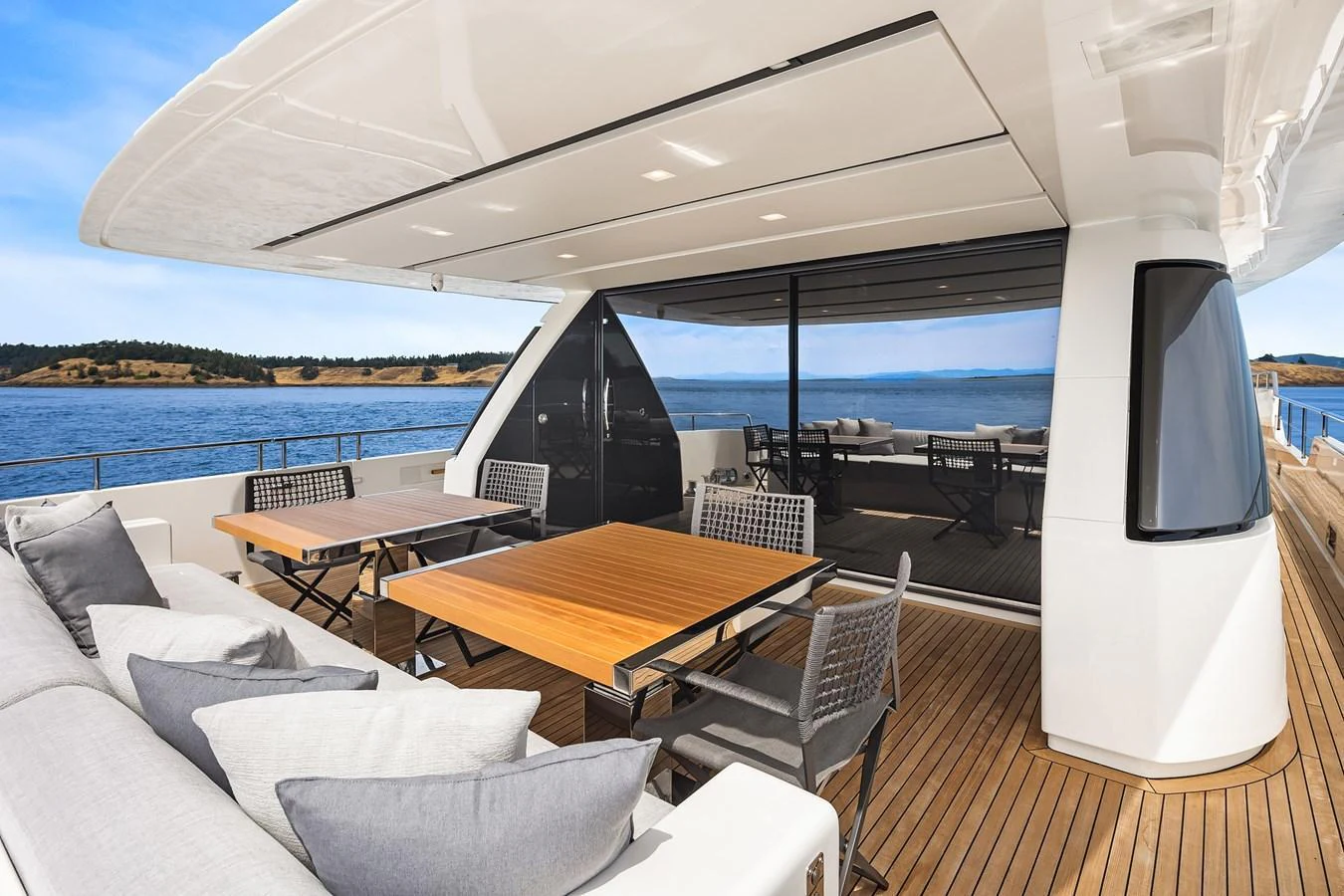 The aft deck features elegant outdoor dining and lounging areas with stunning sea views. aboard ESSENZA Yacht for Sale