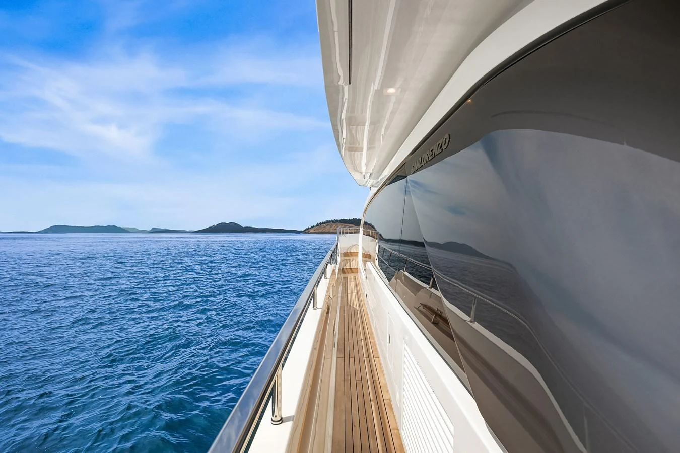 A sleek yacht cruising on calm waters with a view of the horizon. aboard ESSENZA Yacht for Sale