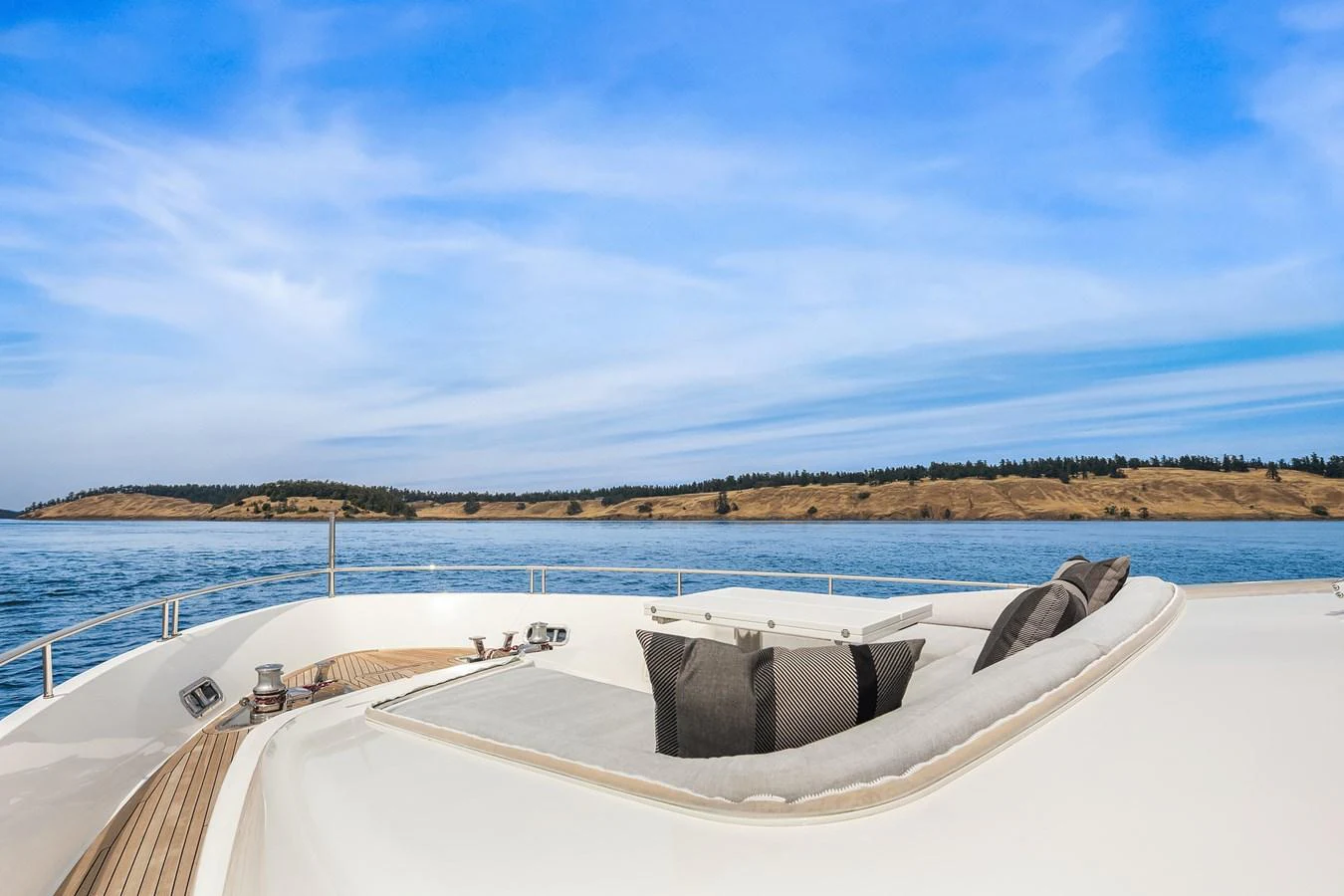 The foredeck features a luxurious sunbathing area with plush cushions and stunning ocean views. aboard ESSENZA Yacht for Sale