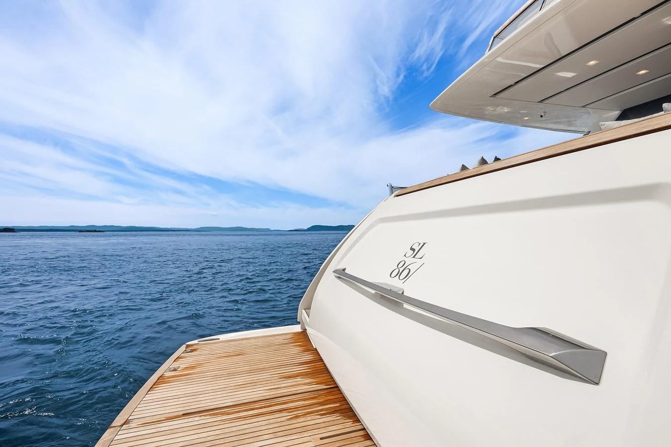 The yacht's stern is showcased against a serene ocean backdrop. aboard ESSENZA Yacht for Sale