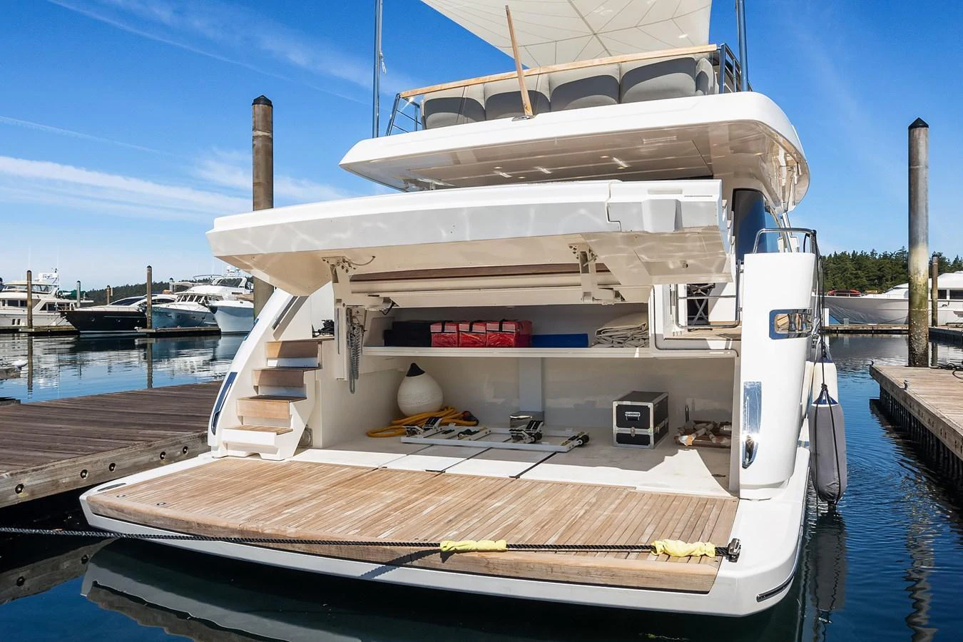 The yacht's aft deck features a spacious storage area and easy access to the water. aboard ESSENZA Yacht for Sale