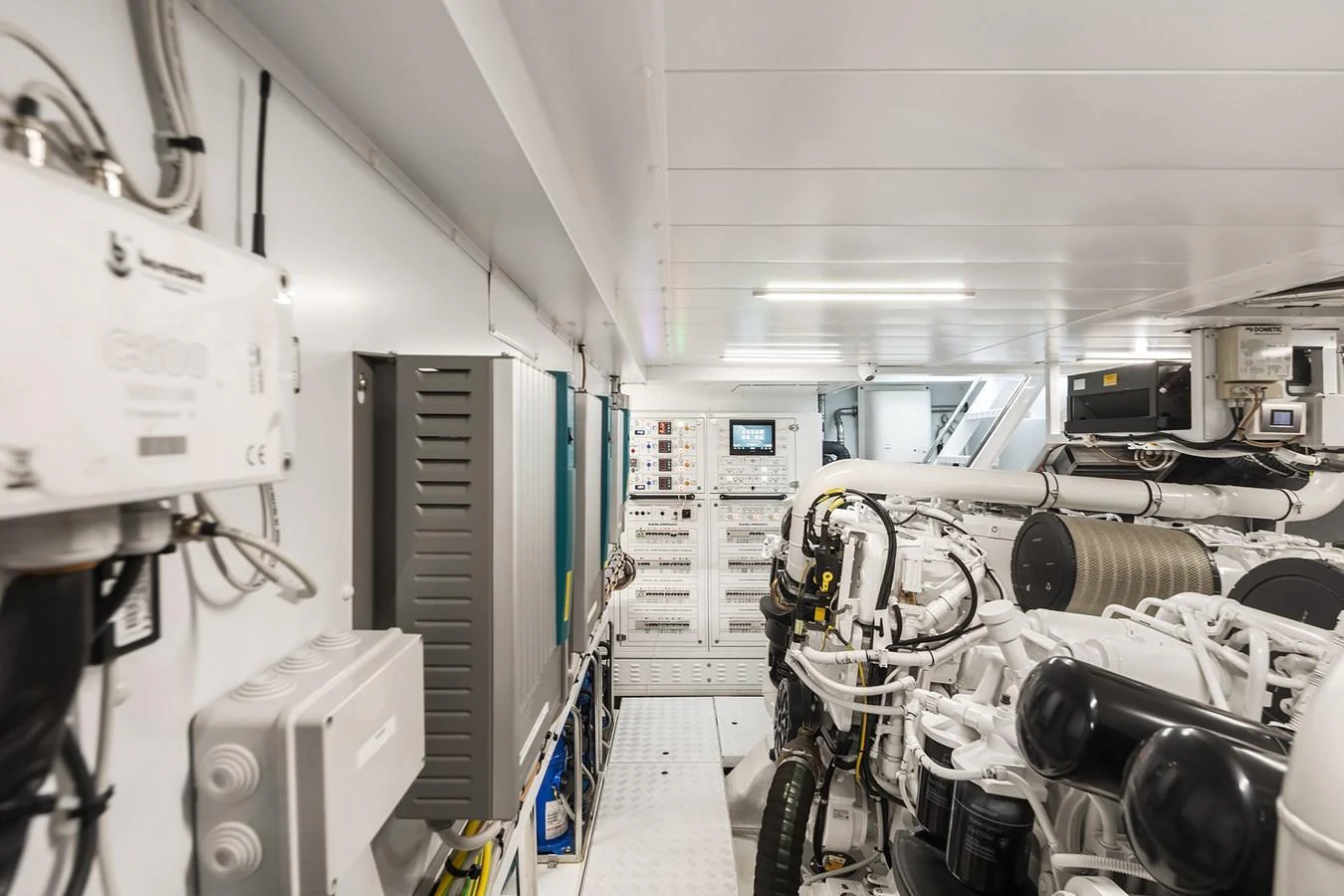 The image showcases the yacht's well-maintained engine room with advanced machinery and control panels. aboard ESSENZA Yacht for Sale