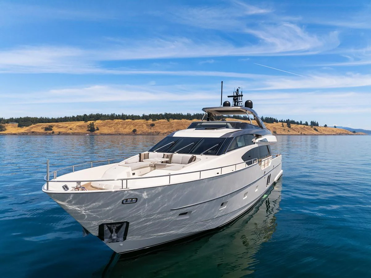 A sleek and modern yacht glides gracefully on calm waters under a clear blue sky. aboard ESSENZA Yacht for Sale