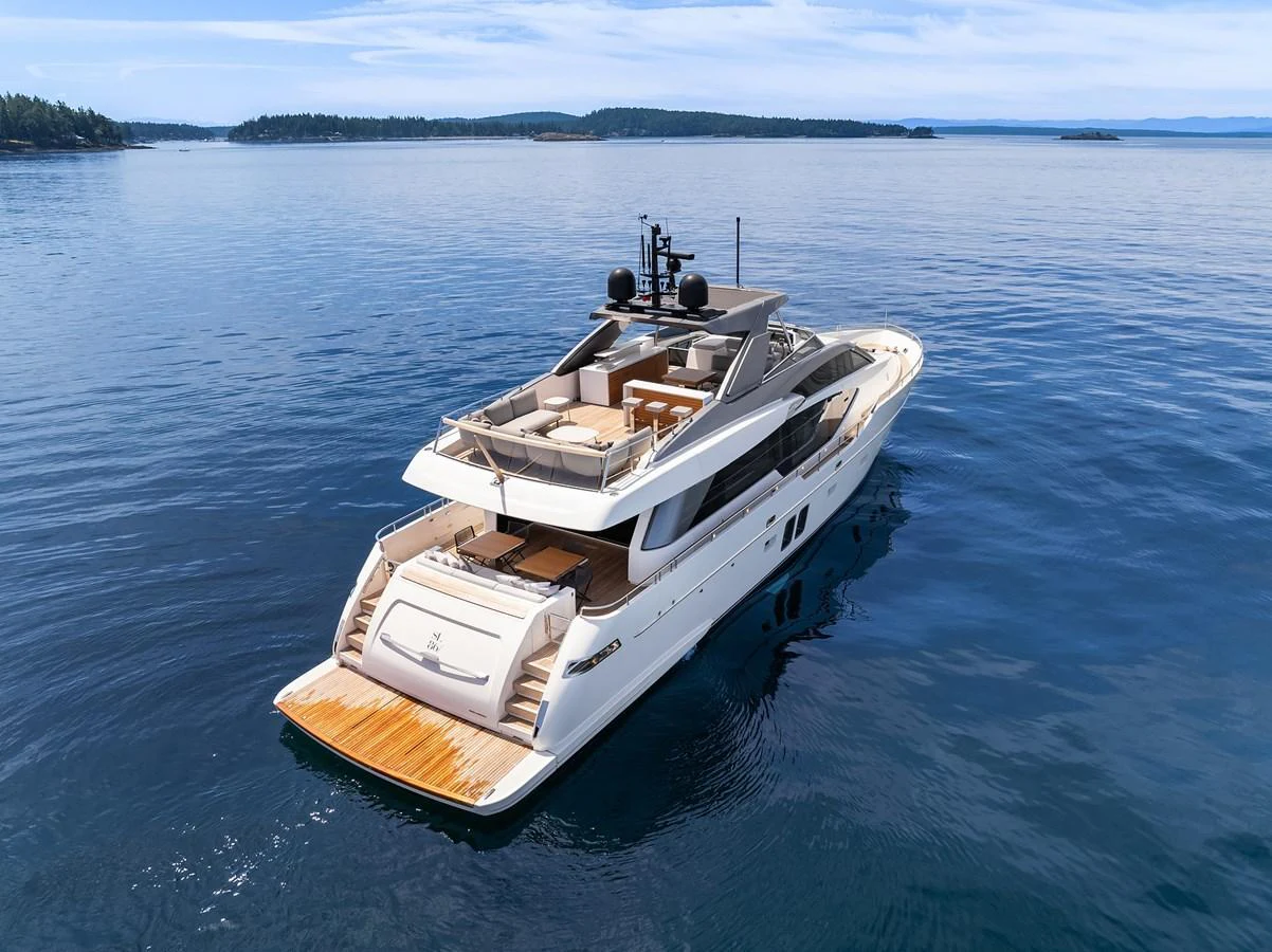 A sleek yacht glides gracefully on calm waters, showcasing its luxurious aft deck and modern design. aboard ESSENZA Yacht for Sale