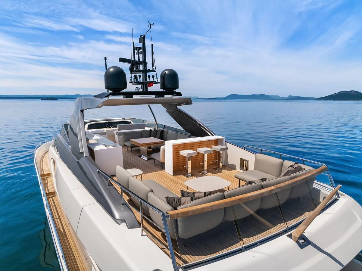 The yacht's aft deck features luxurious seating and dining areas with stunning ocean views. aboard ESSENZA Yacht for Sale