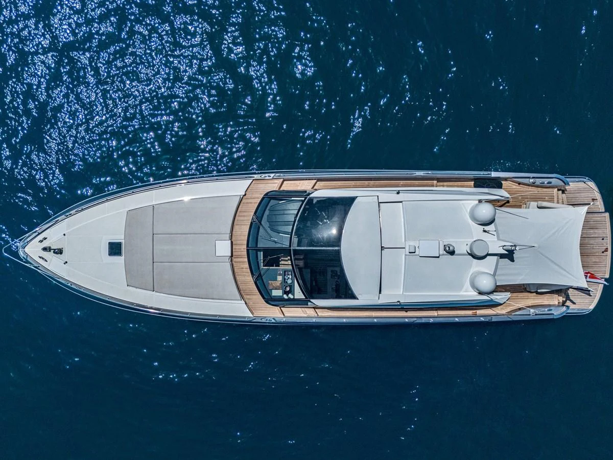A sleek and modern yacht is captured from an aerial view, showcasing its streamlined design and spacious deck areas. aboard LIONESS Yacht for Sale