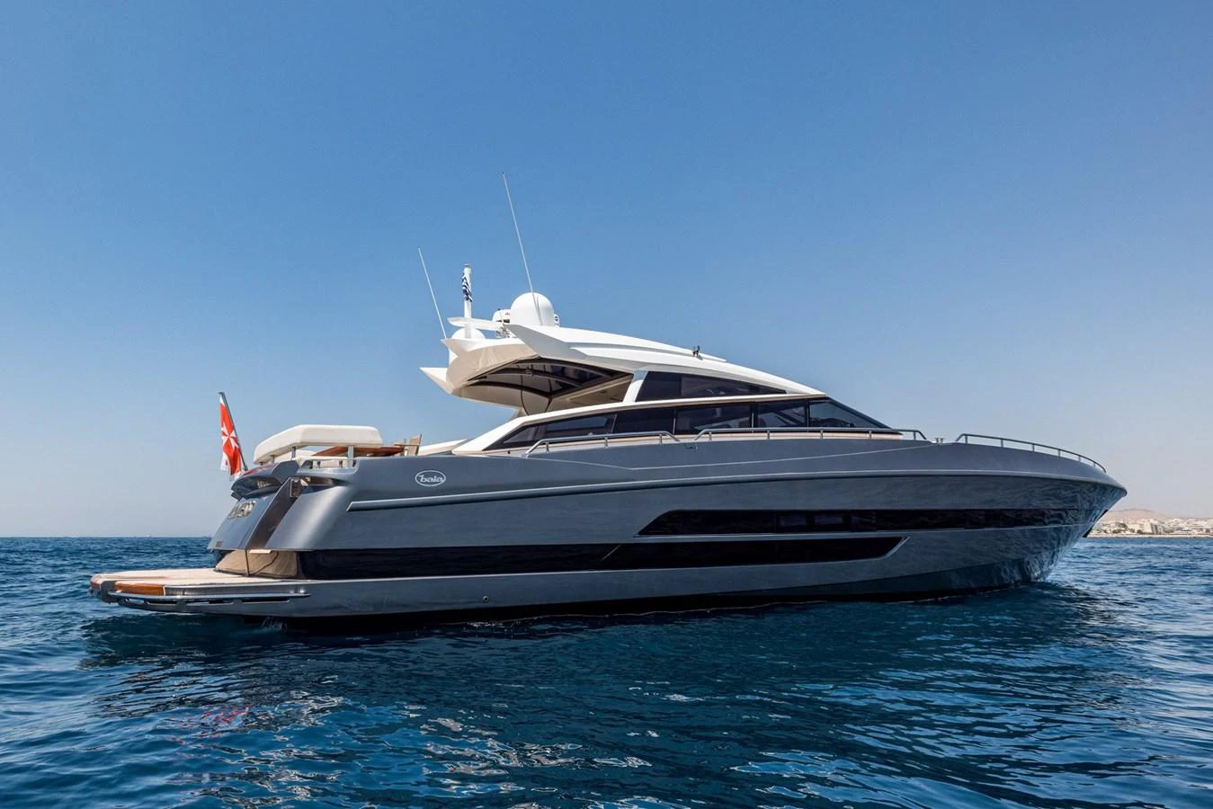 A sleek and modern yacht glides gracefully on calm blue waters under a clear sky. aboard LIONESS Yacht for Sale