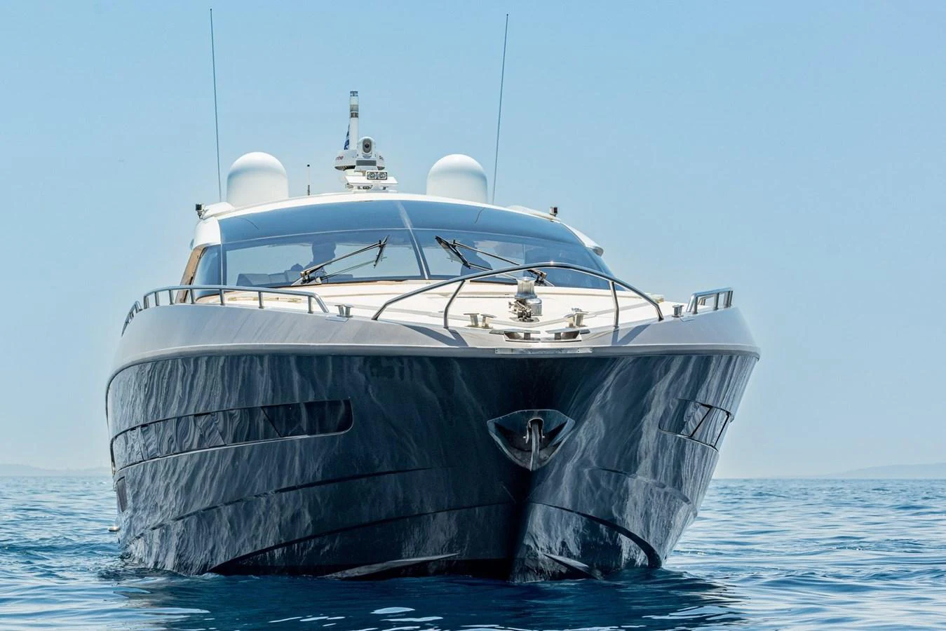 A sleek yacht glides gracefully on calm waters, showcasing its modern design and luxurious appeal. aboard LIONESS Yacht for Sale
