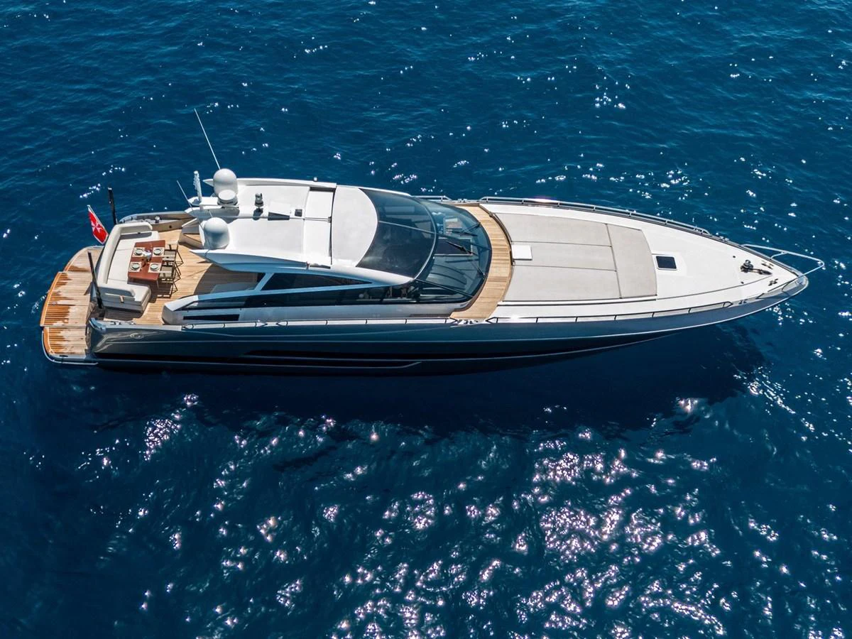 This sleek yacht glides effortlessly over the deep blue waters, showcasing its modern design and luxurious deck space. aboard LIONESS Yacht for Sale