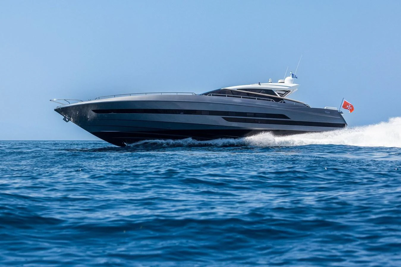 A sleek and modern yacht glides swiftly across the open water, showcasing its elegant design. aboard LIONESS Yacht for Sale