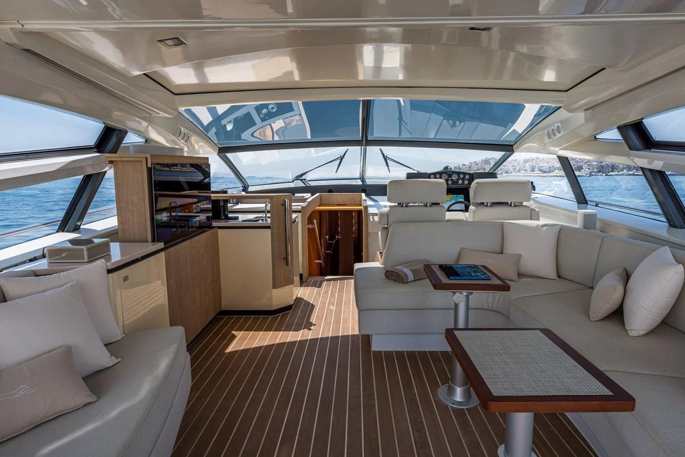 The salon features a spacious and modern design with ample seating and panoramic windows. aboard LIONESS Yacht for Sale