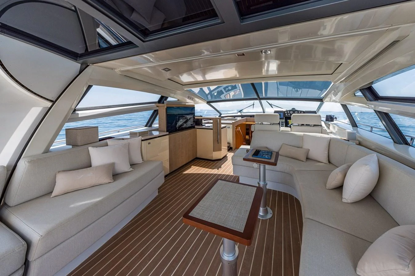 The spacious salon features elegant seating and panoramic windows, offering a luxurious and comfortable environment. aboard LIONESS Yacht for Sale