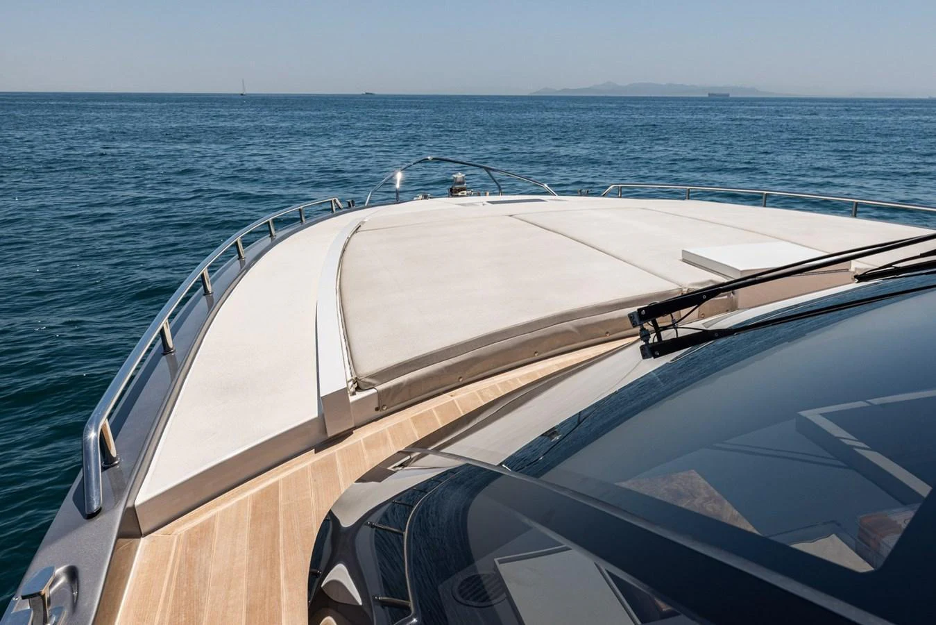 The yacht's sleek bow cuts through the calm blue waters, showcasing its elegant design and luxurious deck space. aboard LIONESS Yacht for Sale