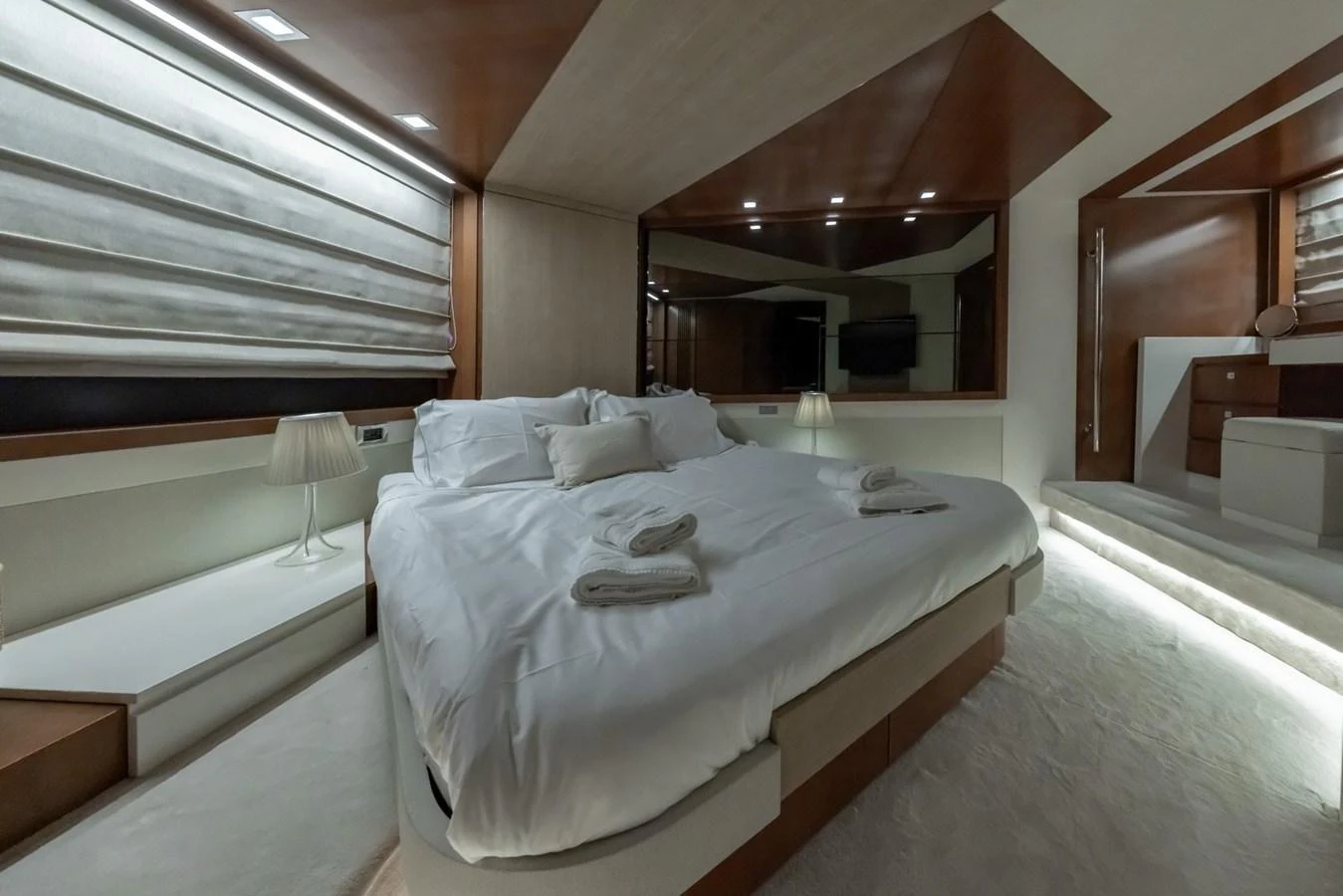The master stateroom features a luxurious bed with elegant lighting and modern decor. aboard LIONESS Yacht for Sale
