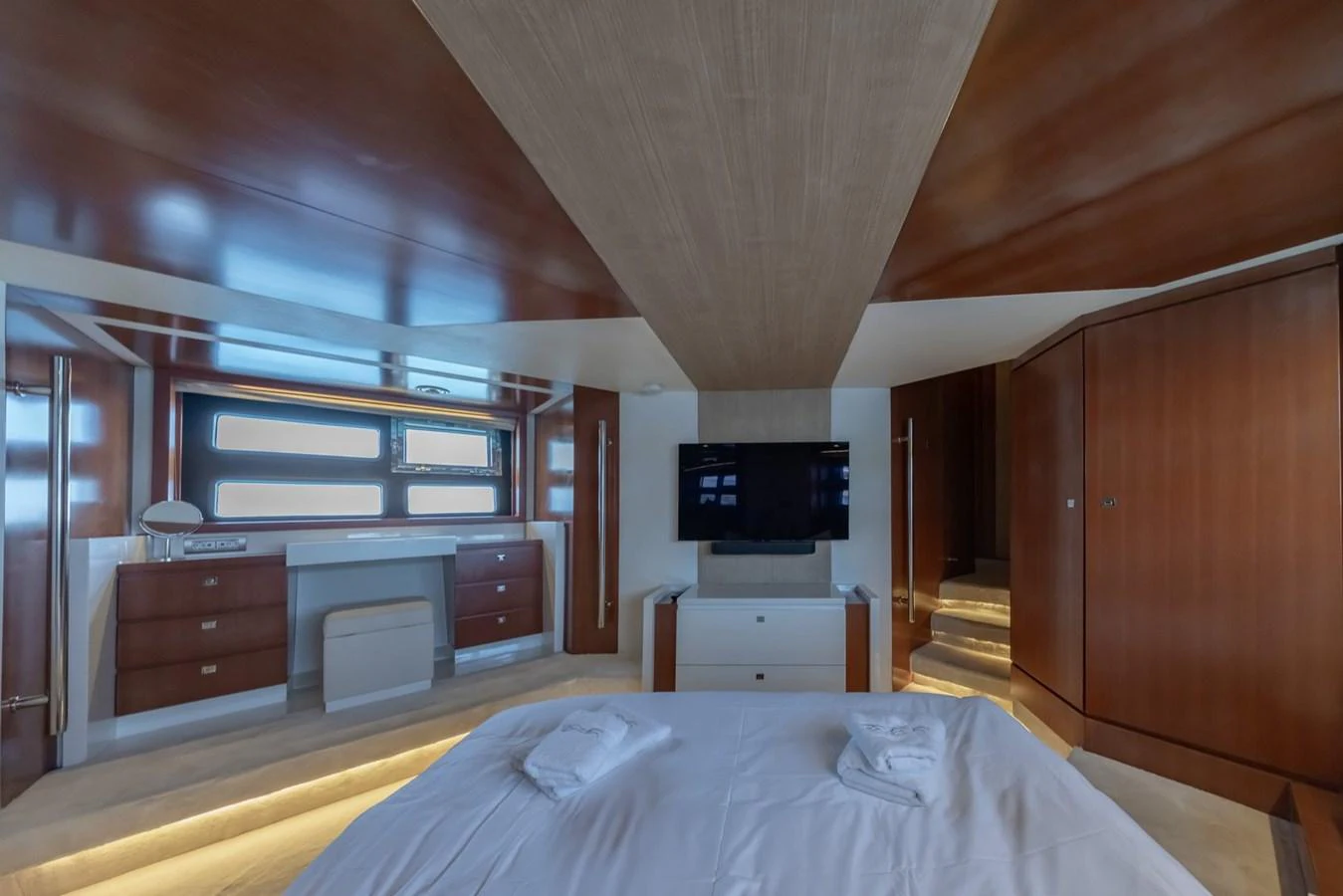 The master stateroom features elegant wood finishes and modern amenities for ultimate comfort. aboard LIONESS Yacht for Sale
