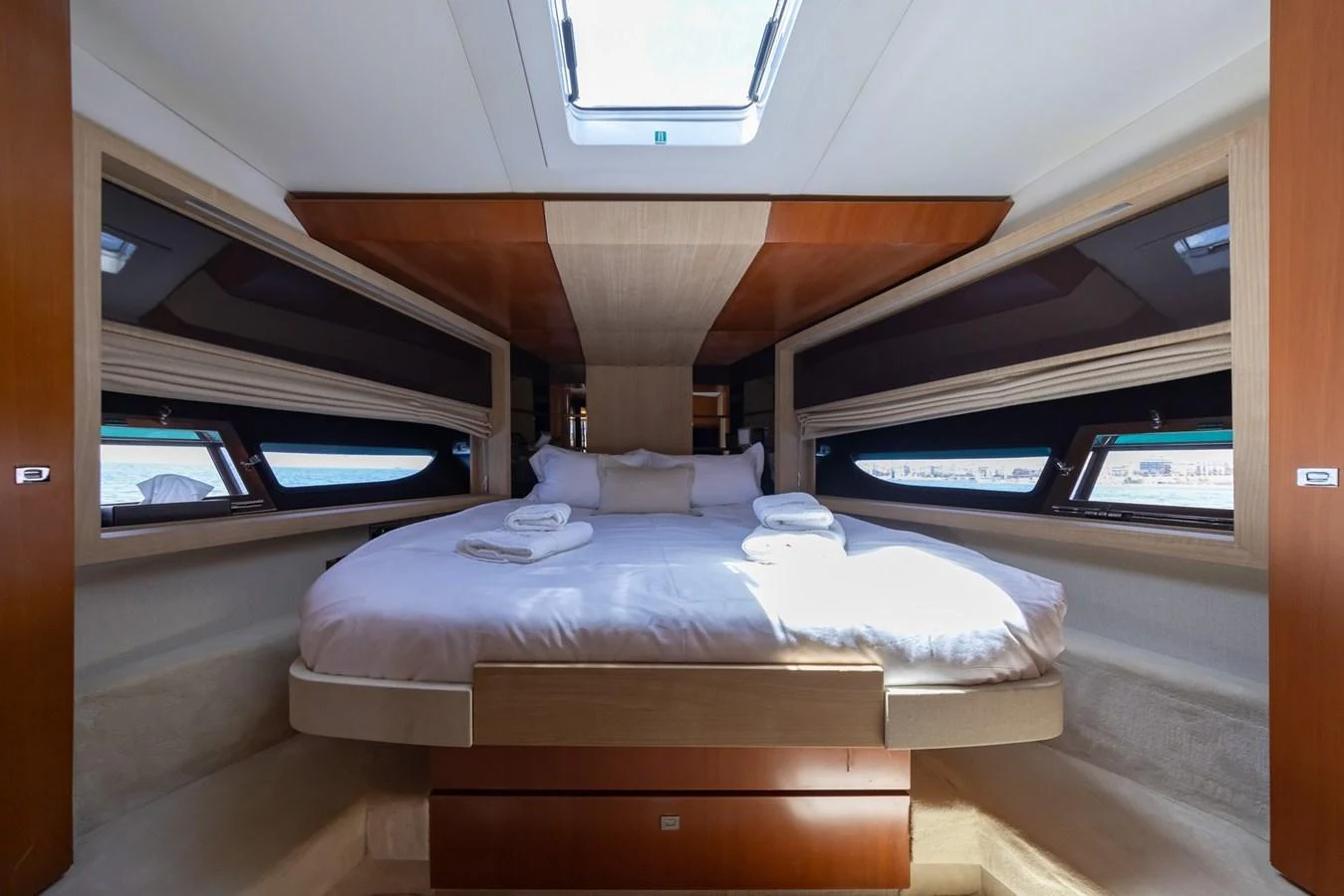 The master stateroom features a spacious bed with ample natural light from the overhead skylight and side windows. aboard LIONESS Yacht for Sale
