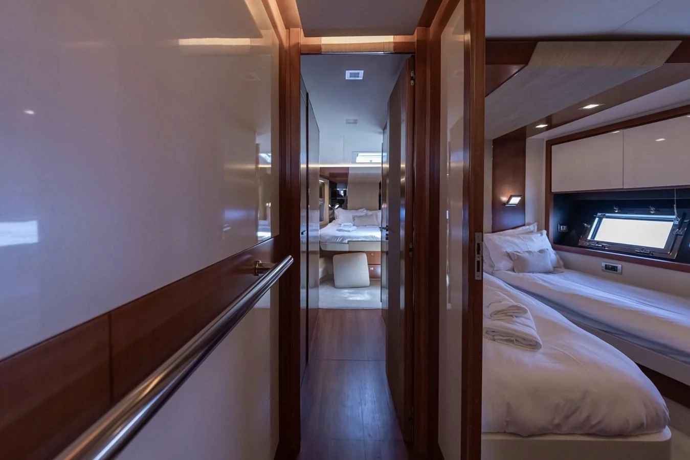 The image showcases a cozy stateroom with a modern design and comfortable bedding. aboard LIONESS Yacht for Sale