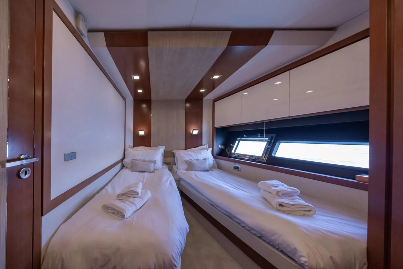 A cozy twin stateroom with neatly arranged beds and soft lighting. aboard LIONESS Yacht for Sale