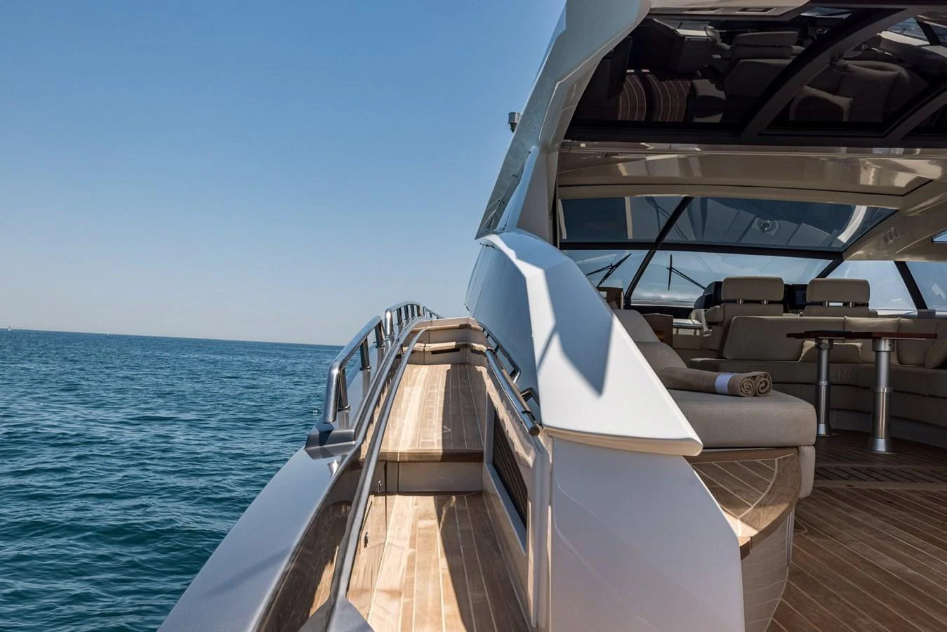 The yacht's side deck offers a sleek passageway with stunning ocean views. aboard LIONESS Yacht for Sale