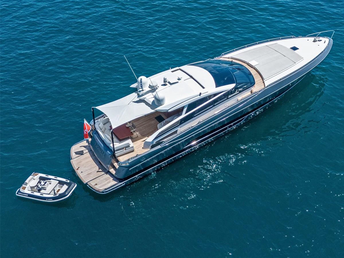 A sleek and modern yacht glides gracefully on the open water, accompanied by a tender. aboard LIONESS Yacht for Sale