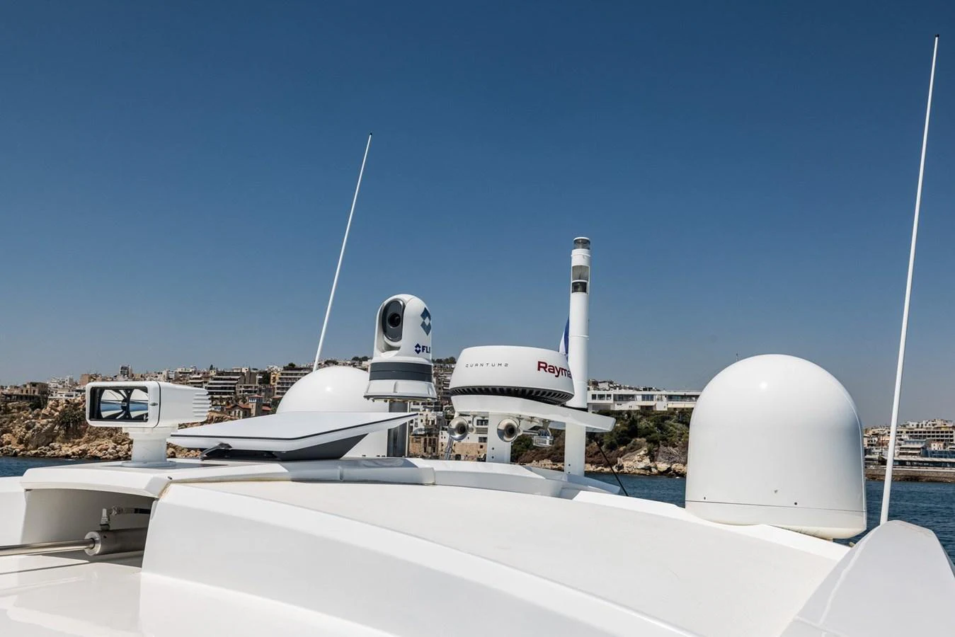 The image showcases the advanced radar and communication equipment on the yacht's roof against a clear blue sky. aboard LIONESS Yacht for Sale