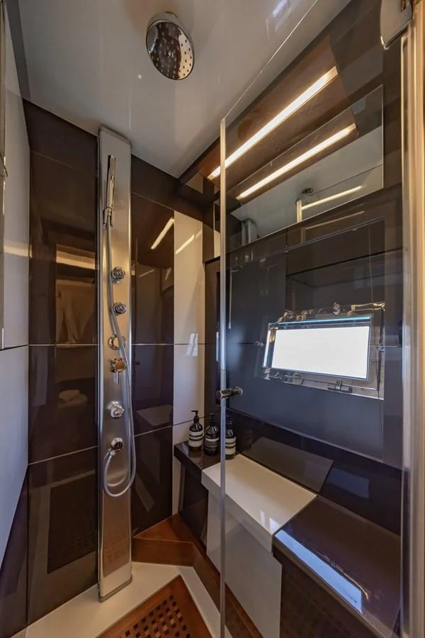 The yacht's bathroom features a sleek, modern design with a glass shower enclosure and stylish fixtures. aboard LIONESS Yacht for Sale