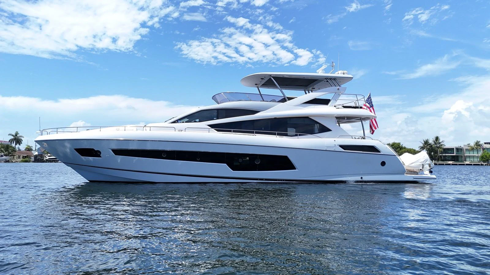 A sleek and modern yacht glides gracefully on calm waters under a clear blue sky. aboard DIRTY DAWG Yacht for Sale