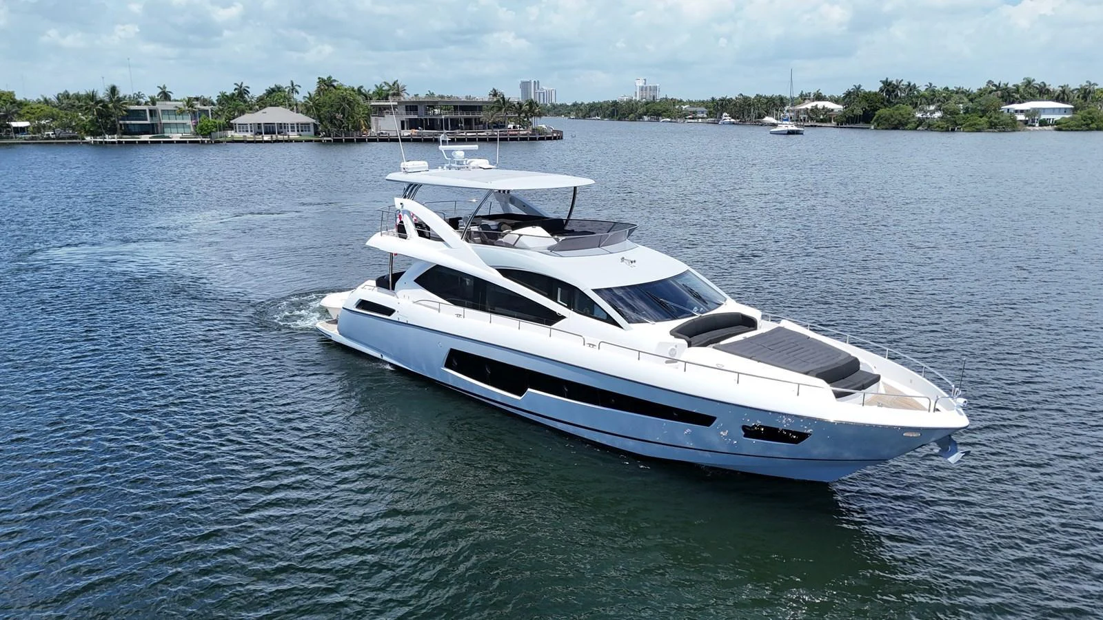 A sleek and modern yacht cruises gracefully on calm waters, showcasing its elegant design and spacious deck areas. aboard DIRTY DAWG Yacht for Sale