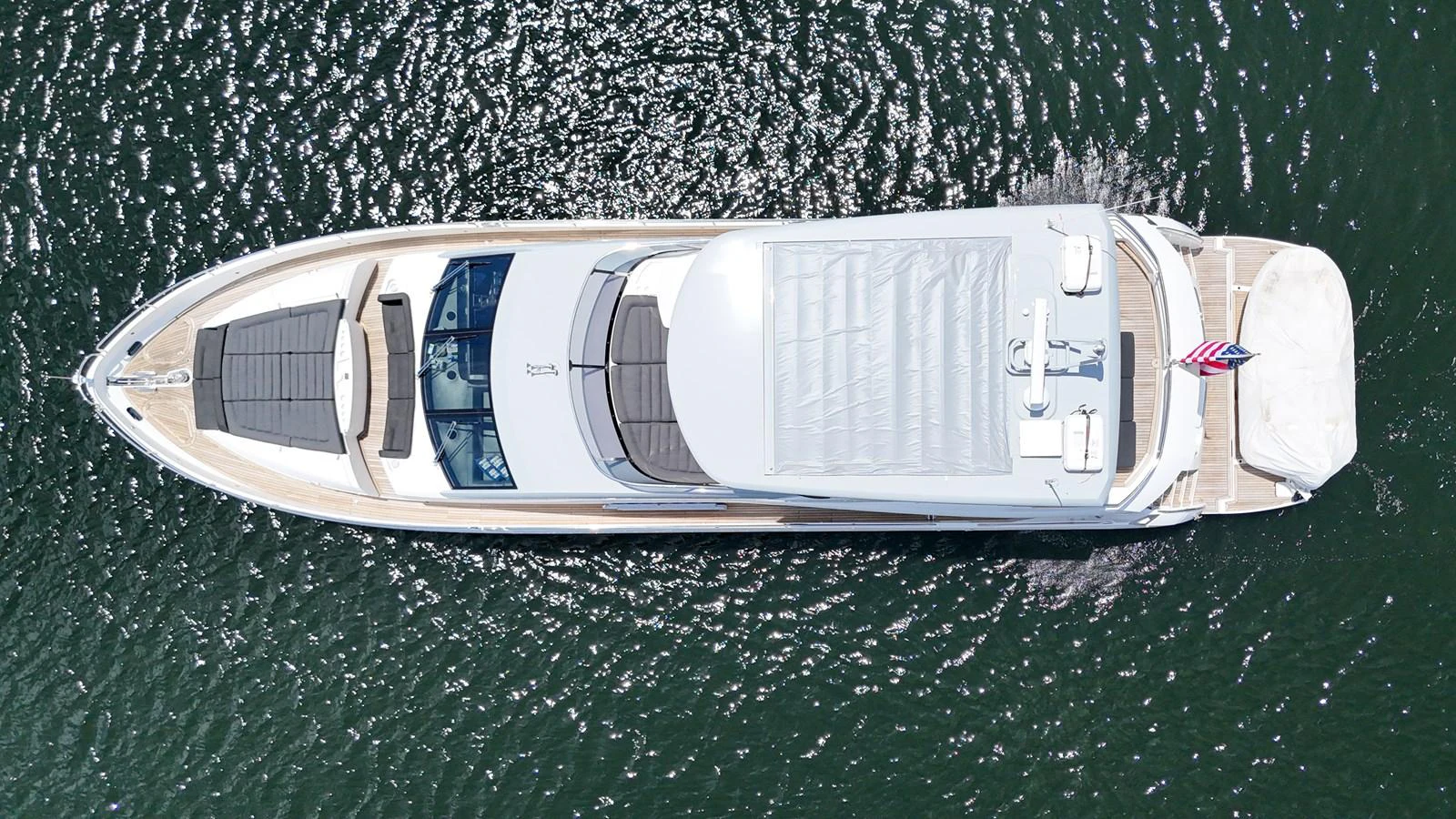 An aerial view of a sleek yacht cruising on the water. aboard DIRTY DAWG Yacht for Sale