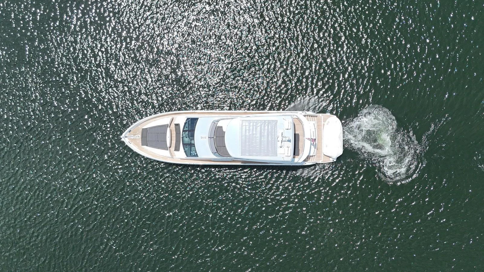 Aerial view of a sleek yacht cruising through the water. aboard DIRTY DAWG Yacht for Sale