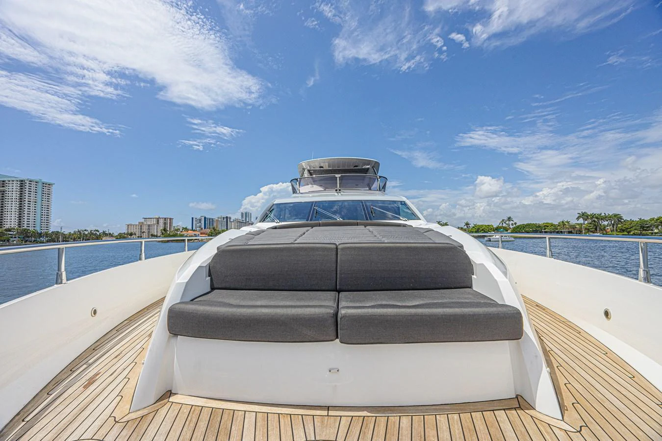 The yacht's foredeck features a spacious sunbathing area with plush cushions, perfect for relaxation under the open sky. aboard DIRTY DAWG Yacht for Sale