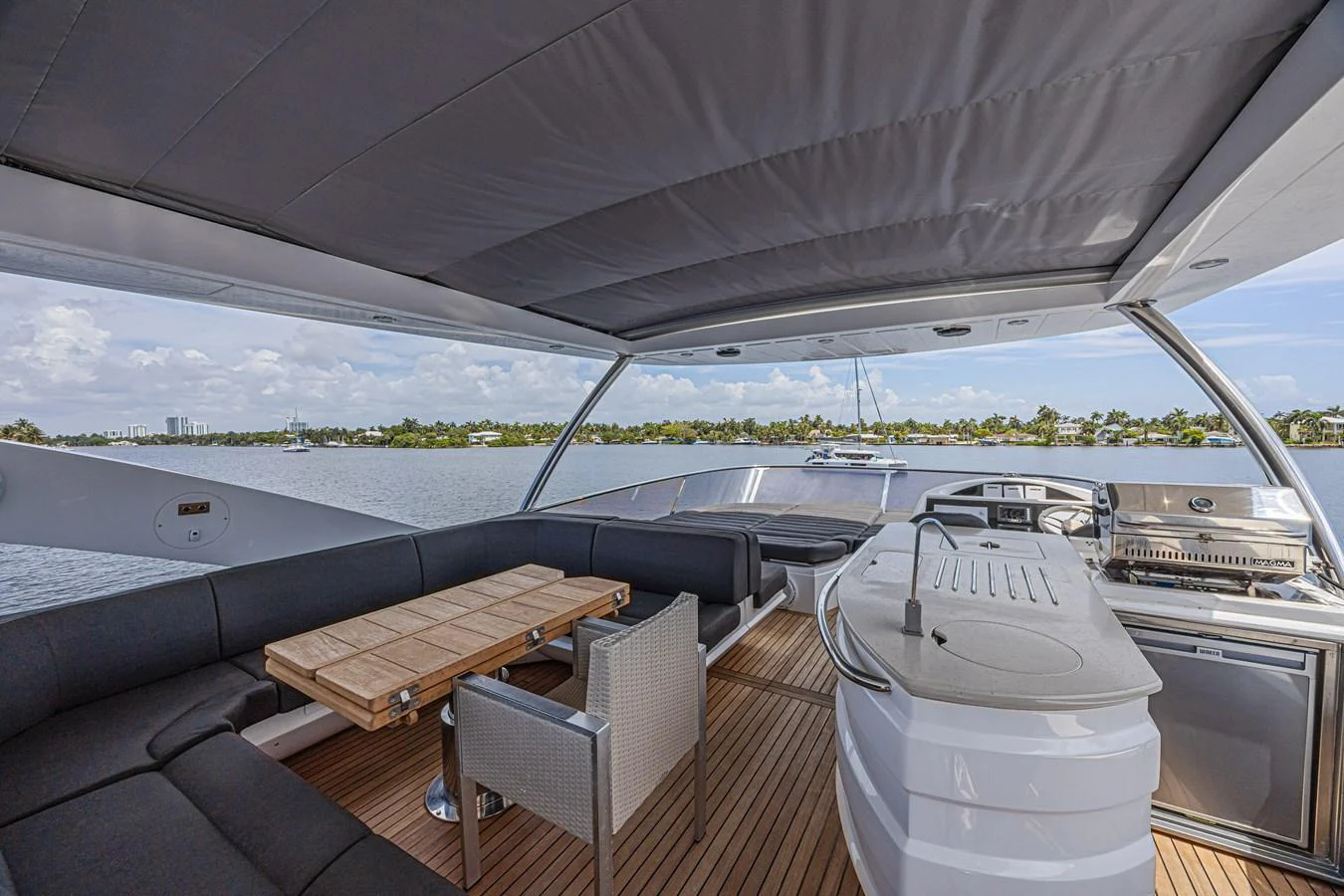 The flybridge offers a spacious and shaded area with comfortable seating and a well-equipped wet bar. aboard DIRTY DAWG Yacht for Sale