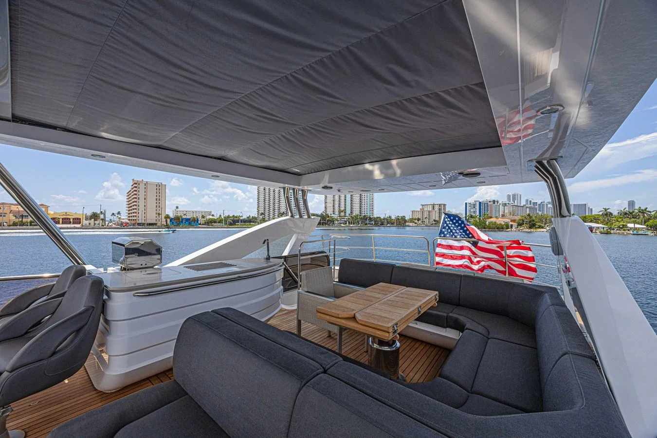 The flybridge offers a spacious seating area with a view of the city skyline. aboard DIRTY DAWG Yacht for Sale