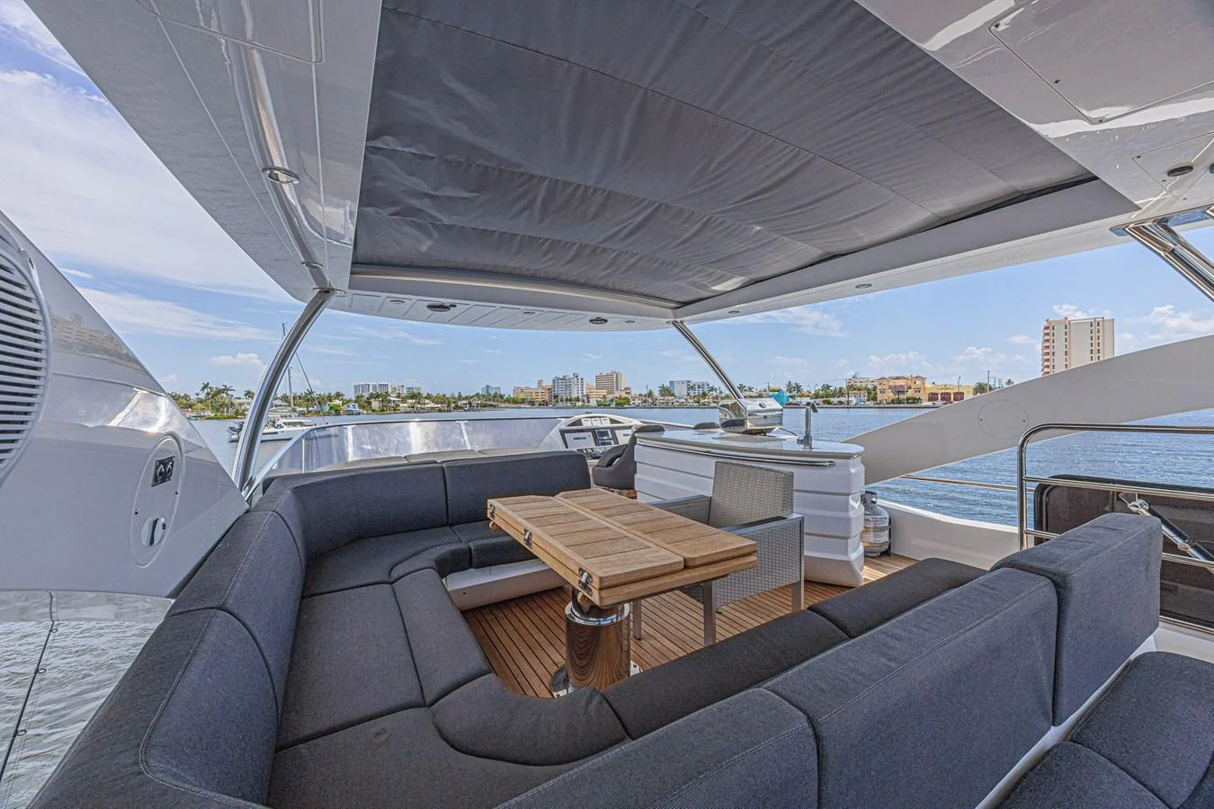 The flybridge offers a spacious seating area with a retractable canopy and a stunning view of the surroundings. aboard DIRTY DAWG Yacht for Sale