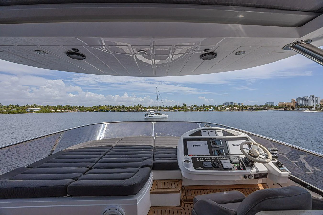 The helm station offers a commanding view with comfortable seating and advanced navigation equipment. aboard DIRTY DAWG Yacht for Sale