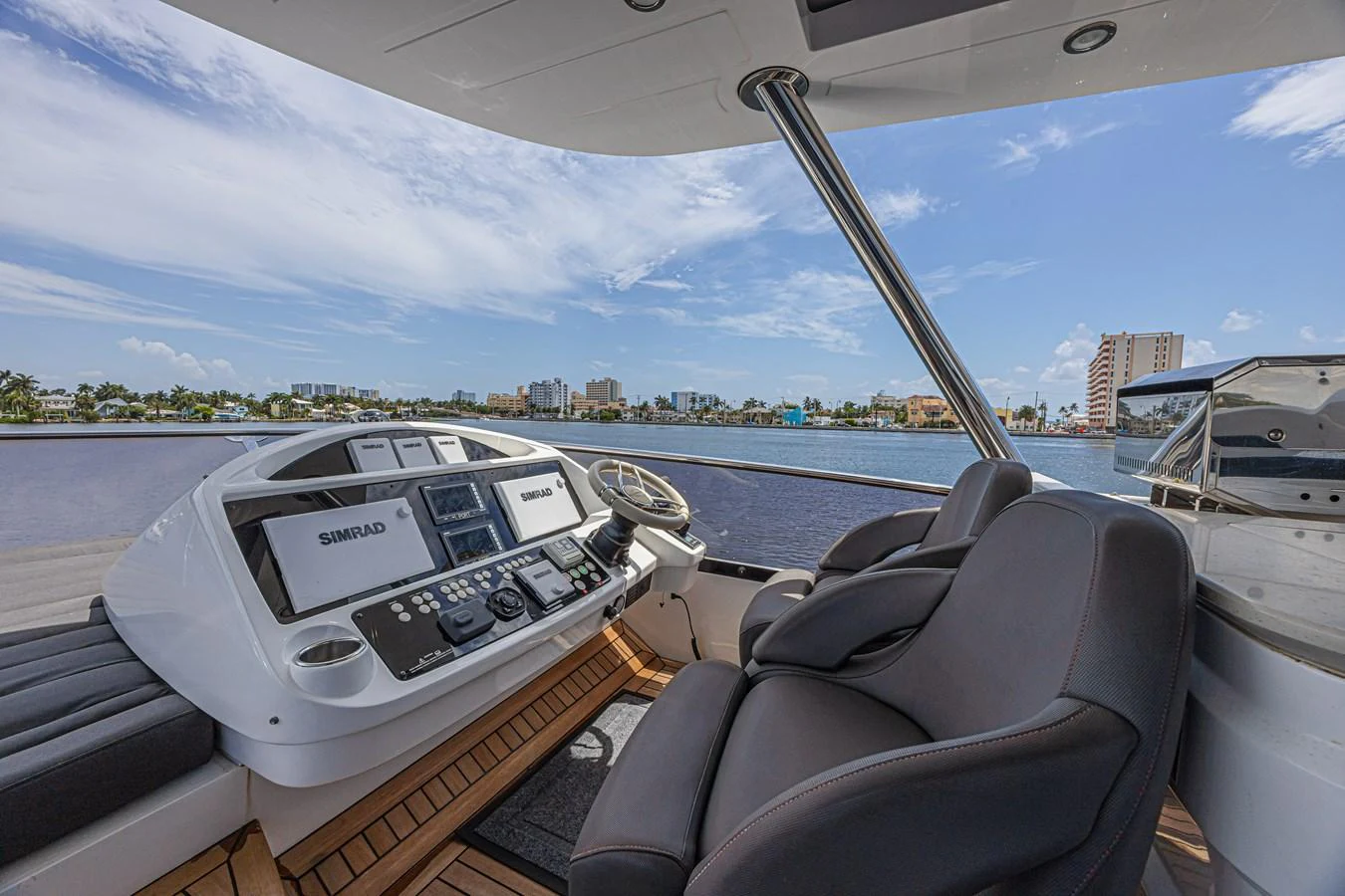 The helm station offers a commanding view with modern navigation equipment and comfortable seating. aboard DIRTY DAWG Yacht for Sale