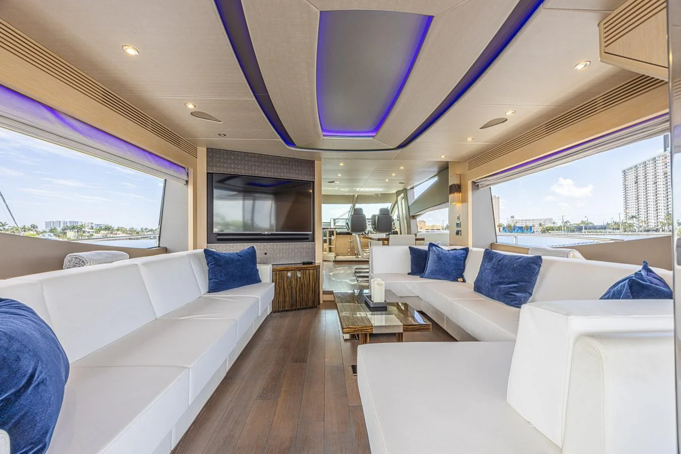 The salon features luxurious seating with a modern design and ample natural light. aboard DIRTY DAWG Yacht for Sale