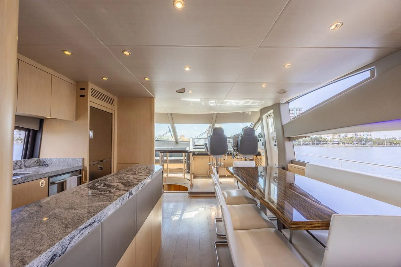 The yacht's dining area features a sleek table with ample seating and modern finishes. aboard DIRTY DAWG Yacht for Sale