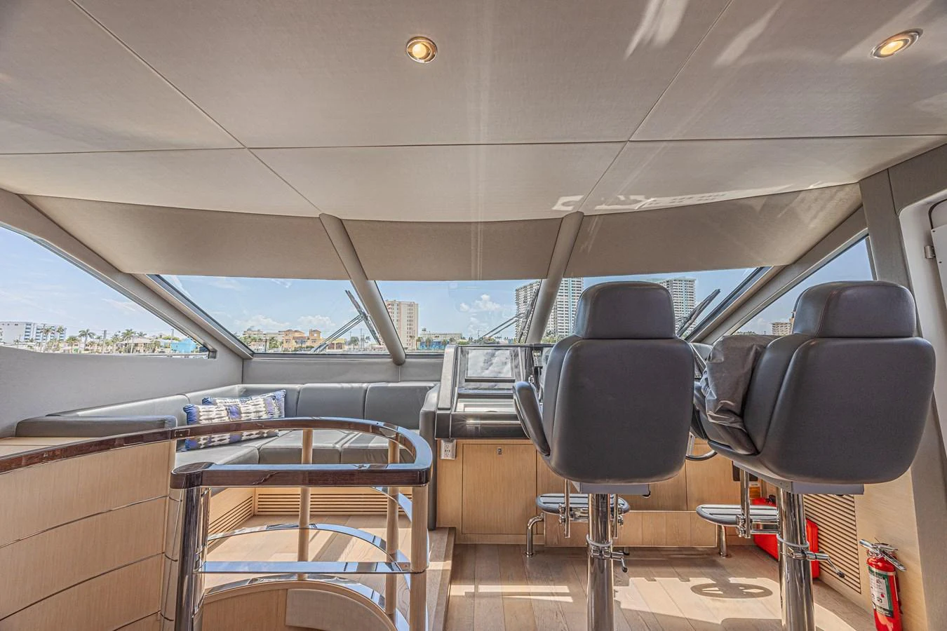 The helm station offers a commanding view with plush seating and modern controls. aboard DIRTY DAWG Yacht for Sale