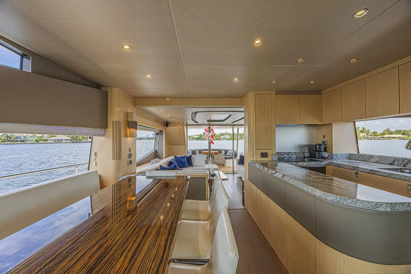 The yacht's galley features modern appliances and a spacious dining area with a view of the water. aboard DIRTY DAWG Yacht for Sale