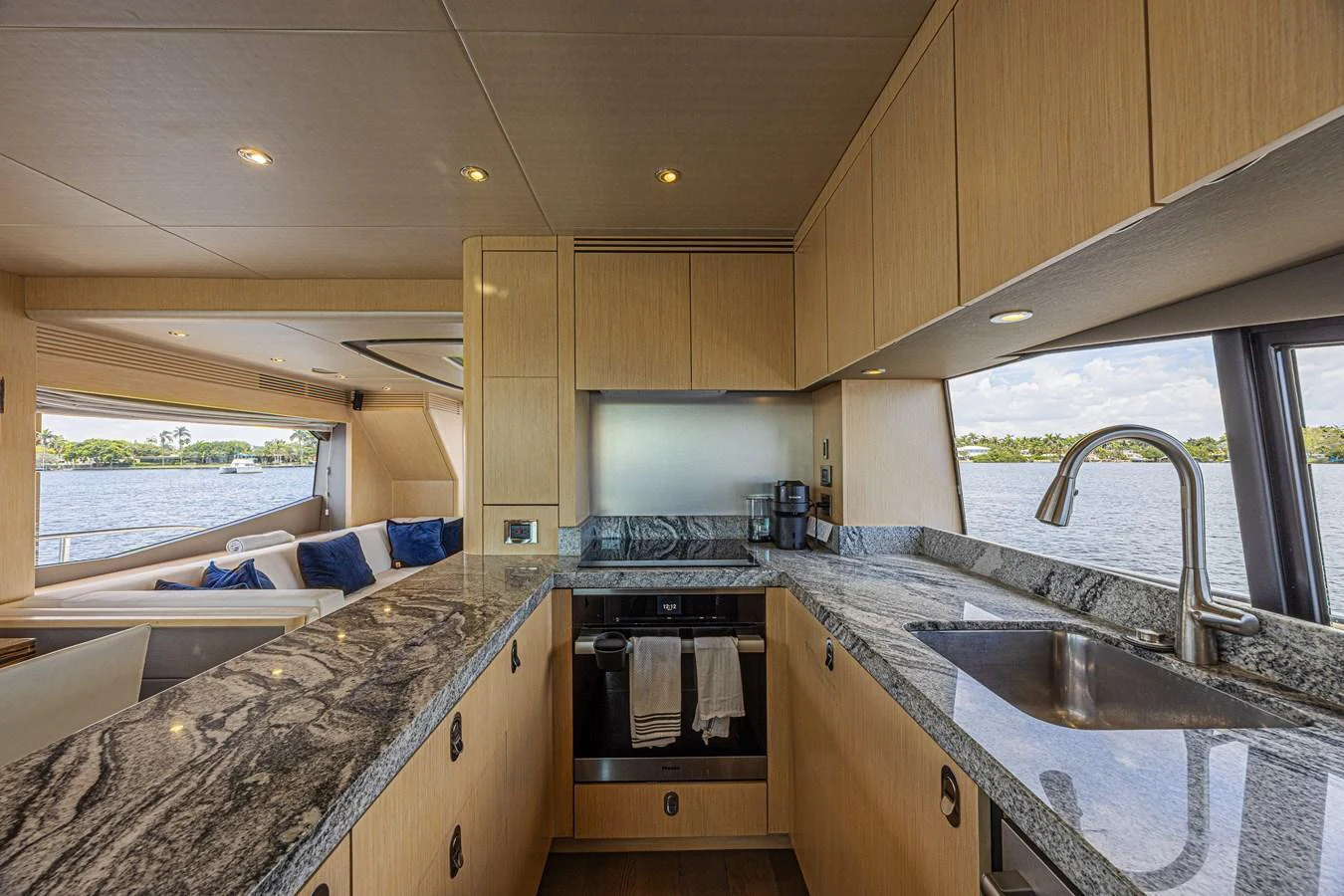 The yacht's galley features modern appliances and a sleek granite countertop, offering a luxurious space for culinary activities with scenic water views. aboard DIRTY DAWG Yacht for Sale