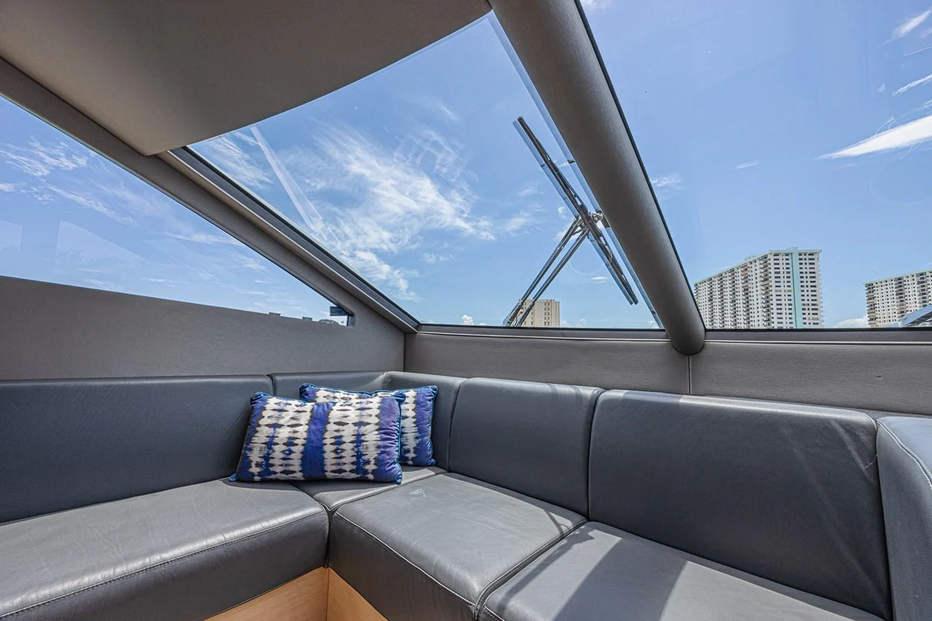 The salon features a sleek, modern design with a large skylight and comfortable seating. aboard DIRTY DAWG Yacht for Sale