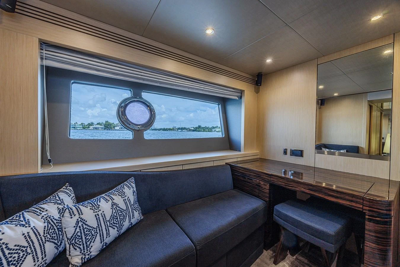 The salon features a comfortable seating area with a large window offering scenic views. aboard DIRTY DAWG Yacht for Sale