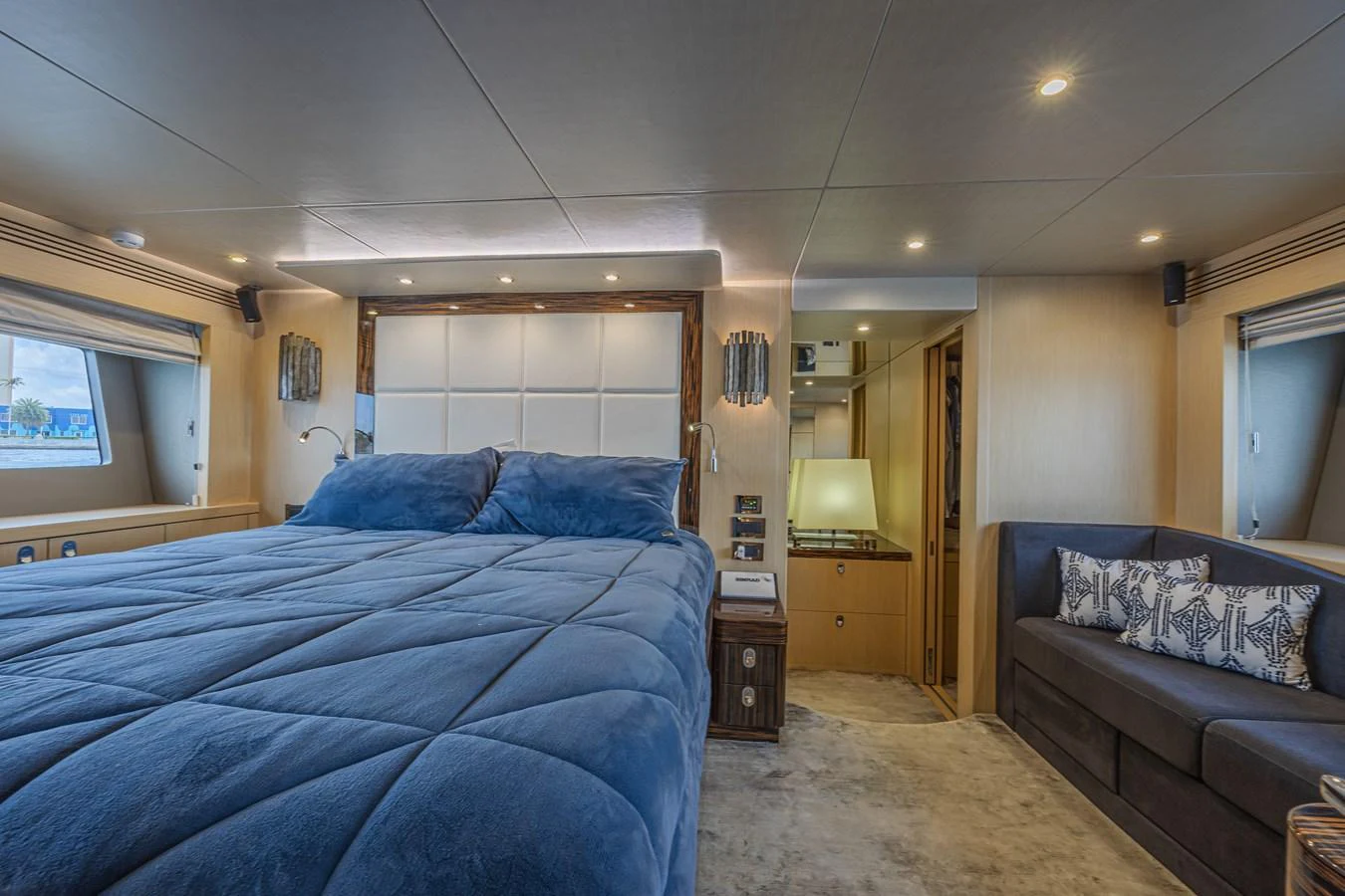 The master stateroom features a plush bed with luxurious bedding and elegant lighting. aboard DIRTY DAWG Yacht for Sale