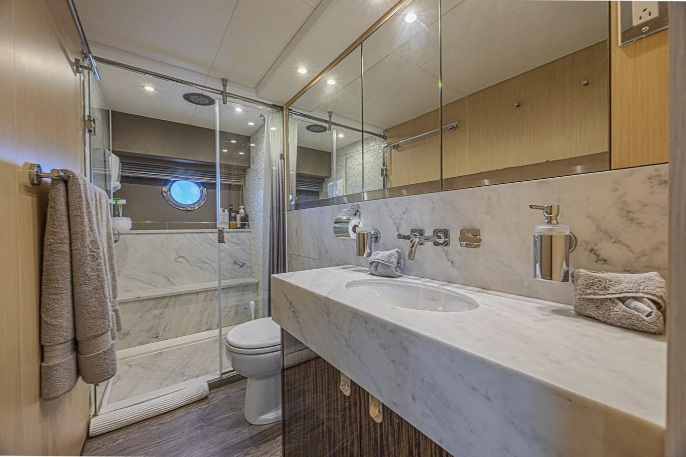 The yacht's bathroom features elegant marble surfaces and modern fixtures. aboard DIRTY DAWG Yacht for Sale